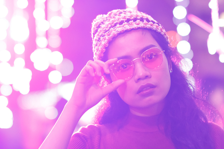 beauty asian woman with glasses and color light bokeh blur on background