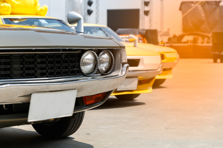 close up front green and yellow retro car parking outsideの写真素材