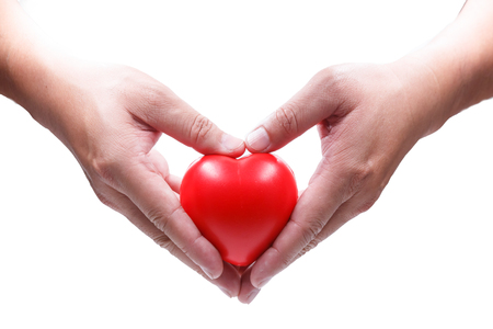 close up hand holding red heart shape isolation on white backgroundの写真素材