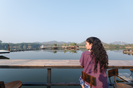 beauty asian woman sitting at chair and beautiful natural view on background, relax and vacatio conceptの写真素材