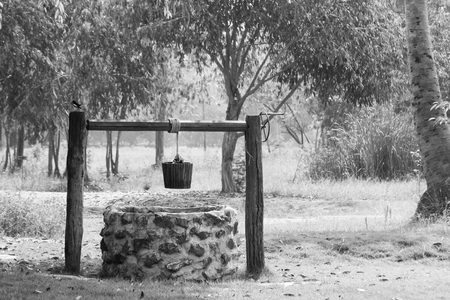 groundwater well in farm, vintage to use water in countryside make with wooden and ropeの写真素材