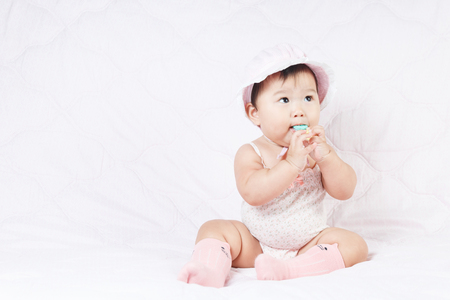 close up asian adorable baby, new born children toddler on soft textile bedの写真素材