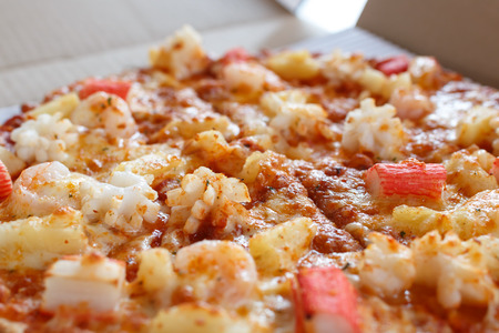 close up seafood pizza with cheese in restaurantの写真素材