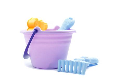 Children's beach toys, in purple bucket isolated o white backgroundの写真素材