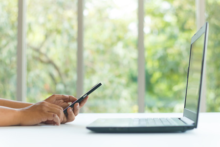 businessman use smartphone on white table for communication conceptの写真素材