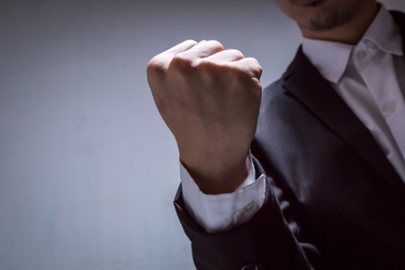close up hand of businessman with black suit, fighting conceptの写真素材