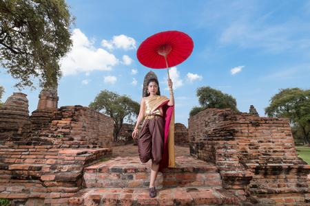 beauty asian woman wearing thai traditional costume in old historic temple at Ayutthayaの写真素材