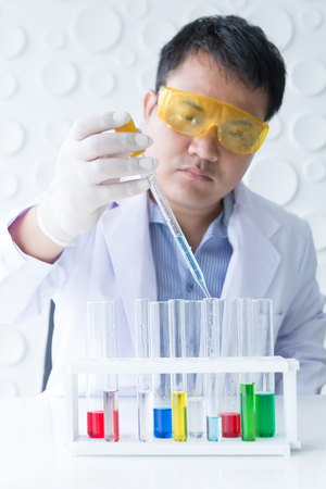 asian doctor diagnosefish with testtube in laboratory, chemistry medical conceptの写真素材