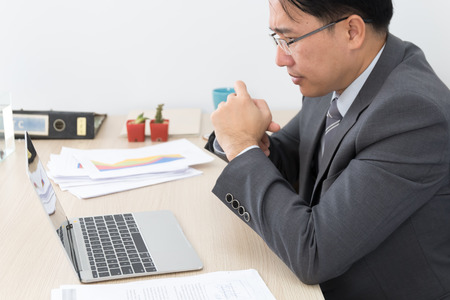 asian business man sitting in office and use laptop, stress conceptの写真素材