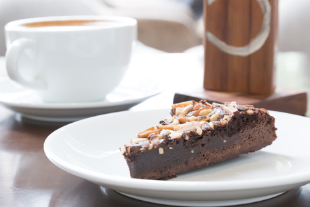 close up chocolate brownie in white dish on wooden tableの写真素材
