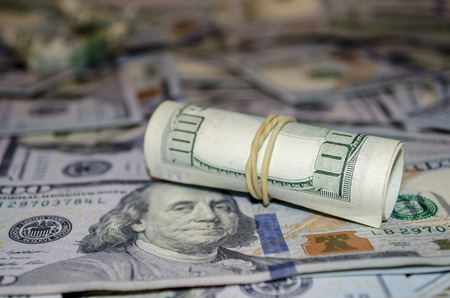 rolled dollar banknote on dollar More background.