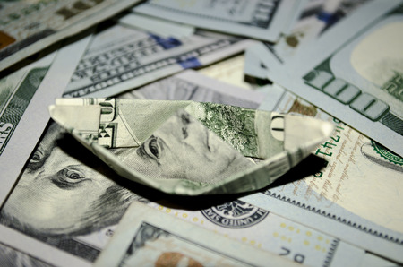 boat dollar banknote on More dollar background.の写真素材