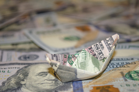 boat dollar banknote on More dollar background.の写真素材