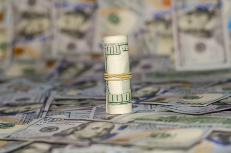rolled dollar banknote on dollar More background.の写真素材