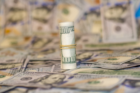 rolled dollar banknote on dollar More background.の写真素材