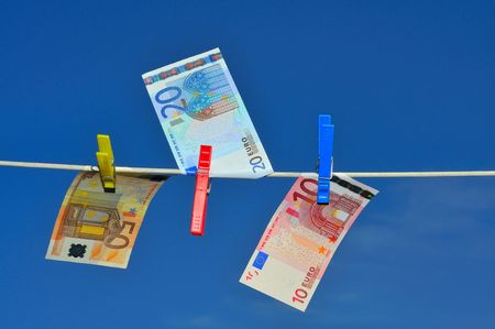 Bills on a clothesline blowing in the wind.の写真素材