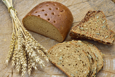 cereal wheat, and bread on a wooden table.