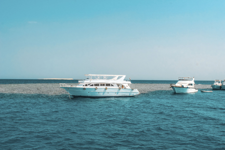 A large private motor yacht under way sailing out on tropical sea. Luxury yacht.の写真素材