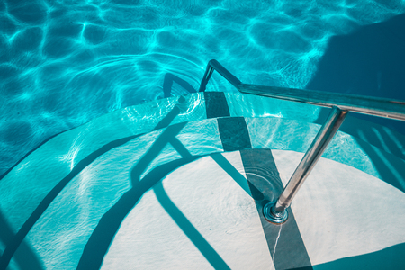 Swimming pool with white stairs in the hotel. View from aboveの写真素材