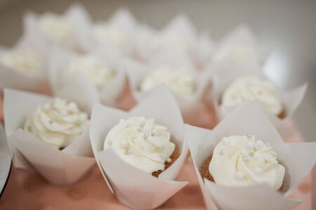 White wedding cake with flowers and blueberries on the tableの写真素材