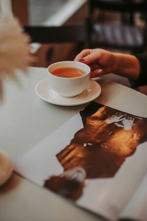 Morning workplace: cup of coffee and business objects on the tableの写真素材