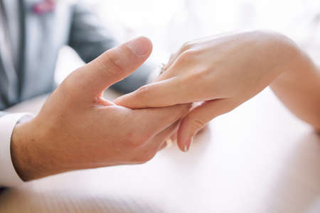 gentle touch of the hands of a man and a woman. husband gently strokes his wife on the hand, Close-upの写真素材