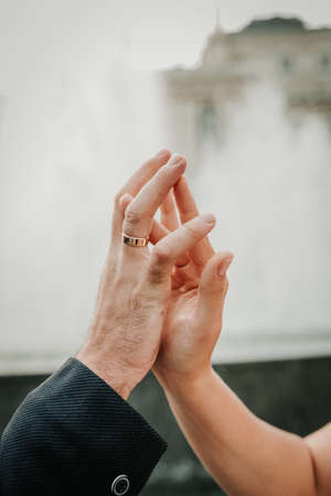 The hands of a man and a woman gently touch each other. Relationship conceptの写真素材