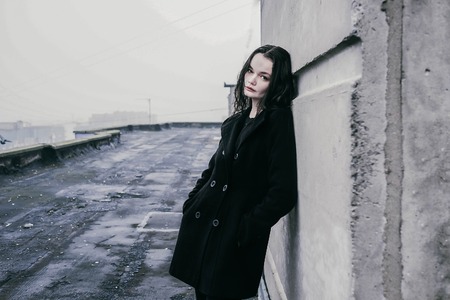 Fashionable brunette on the roofの写真素材