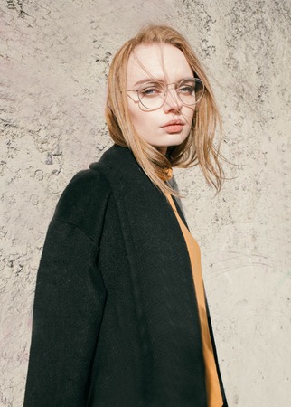 portrait of a beautiful young blond woman with glassesの写真素材