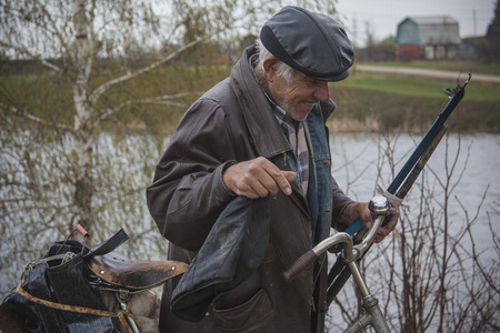 Man is returning from fishing with his bicycle. Russia, summer.のeditorial素材