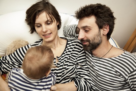 a mother and a father are admiring their child. Russia.の写真素材