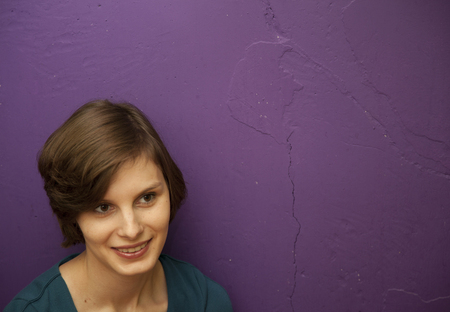 a portrait of the young cute beautifull woman near the wall. Russia.の写真素材