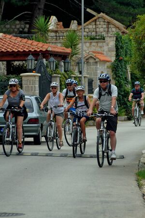 DOBROTA, MONTENEGRO, September 21, 2016: a group of older people ride bicyclesのeditorial素材