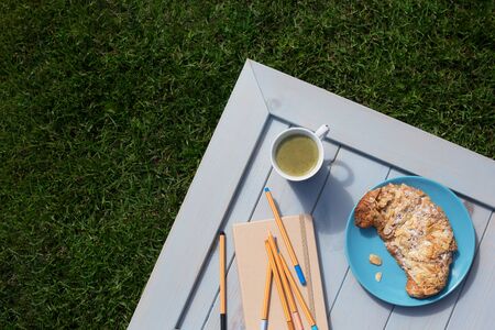 Almond croissant, matcha latte and pens for sketchingの写真素材