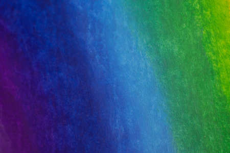 Color gradient background from green to blue and violet created using wax crayons