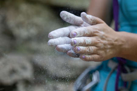 Female hands with magnesium. Woman is preparing to climb. Rock-climbing and active leisure concept....