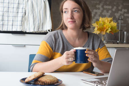Young woman working in home office. Autumn entourage. New normal concept