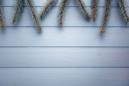 Flat lay with wooden background and silver spruce. Christmas and new year background in gray and...
