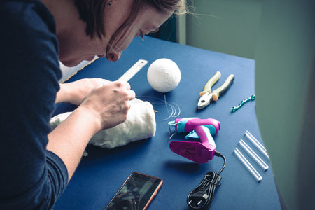 The woman crafting decoration for kids room.の写真素材