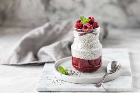 Chia pudding with fresh berries in glass jar. Concept of healthy eating, healthy lifestyle, dieting, fitness menu. Copy spaceの写真素材