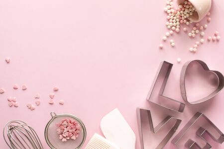 Frame of food ingredients for baking on a gently pink pastel background. Cooking flat lay with copy...