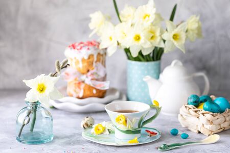 Traditional cupcake Easter cake. Easter cake, colored eggs and spring flowers. Horizontal