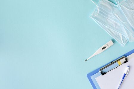 medical concept on a blue background. stethoscope, pills, tablet, notepad, sheet of paper, pen....