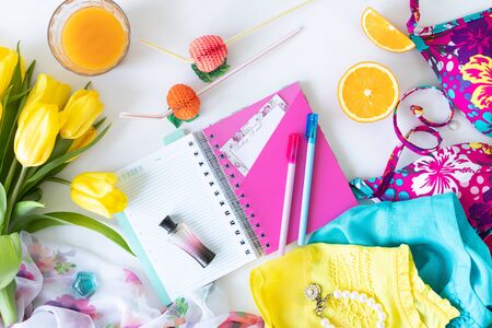 Colorful summer women fashion flat outfit. Dress, sunglasses, cosmetics, perfume, flowers on a white background, top view, wide composition. Summer fashion, vacation concept. Flat layの写真素材
