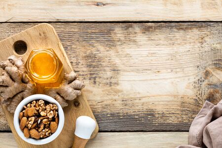 set of products to boost the immune system. Honey, lemon, nuts, ginger to Immunity boosting. top view.の写真素材
