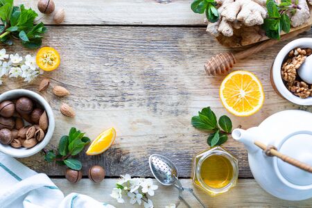 Healthy products for Immunity boosting on wooden background with copy space top view. Lemon, nuts, ginger to immune system.の写真素材