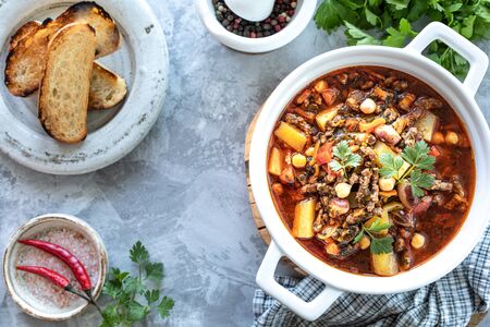 Thick minced meat soup with tomatoes, beans, chickpeas and vegetables. Healthy dinner. View from...