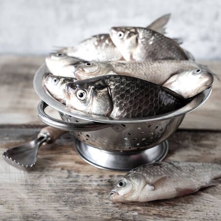 Fresh fish caught in the river on a wooden tableの写真素材