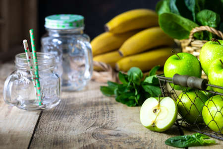 group of healthy green apples, spinach, bananas and mint are ingredients for a smoothie. Detox, diet, healthy, vegetarian food conceptの写真素材