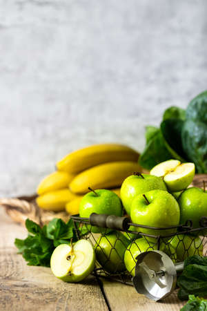 group of healthy green apples, spinach, bananas and mint are ingredients for a smoothie. Detox, diet, healthy, vegetarian food concept. Free space for text. Copy spaceの写真素材